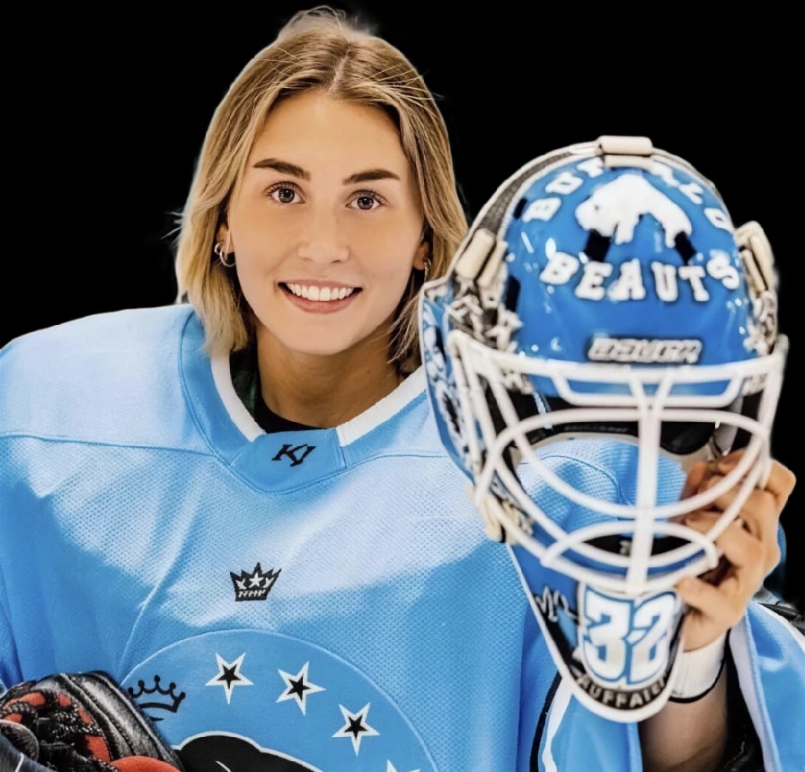 Kassidy Sauvé smiling, holding her goalie mask