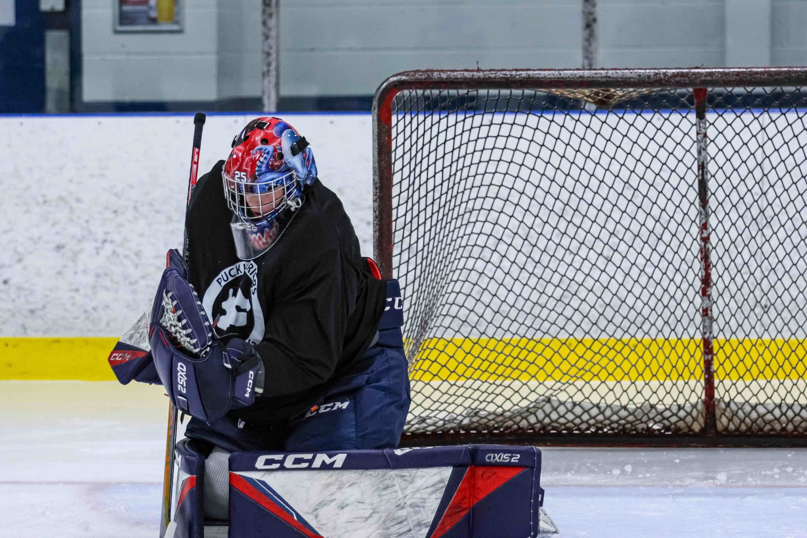 Young goalie making a pad save in a private lesson