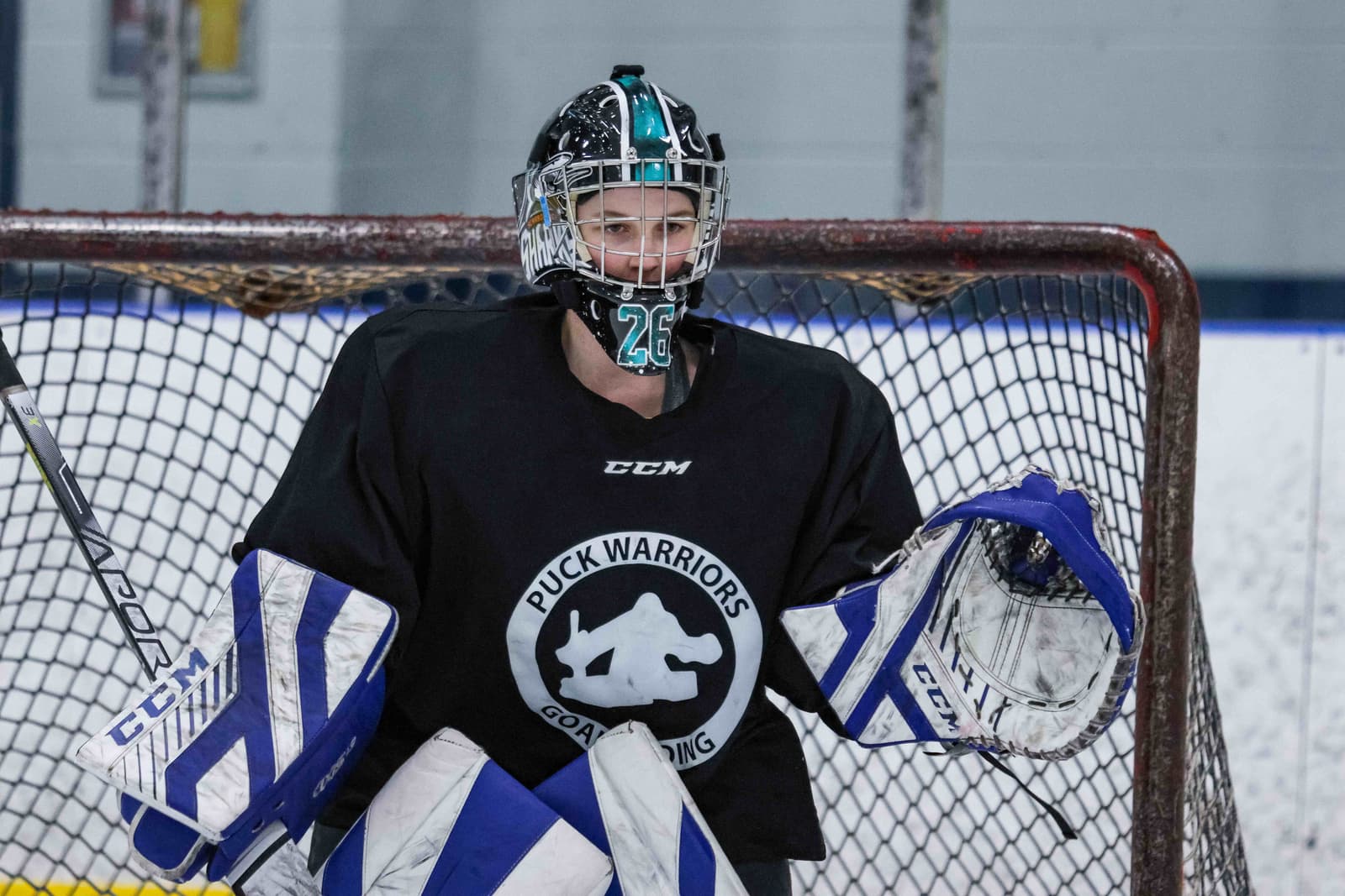Goalie in a PWG jersey in full gear
