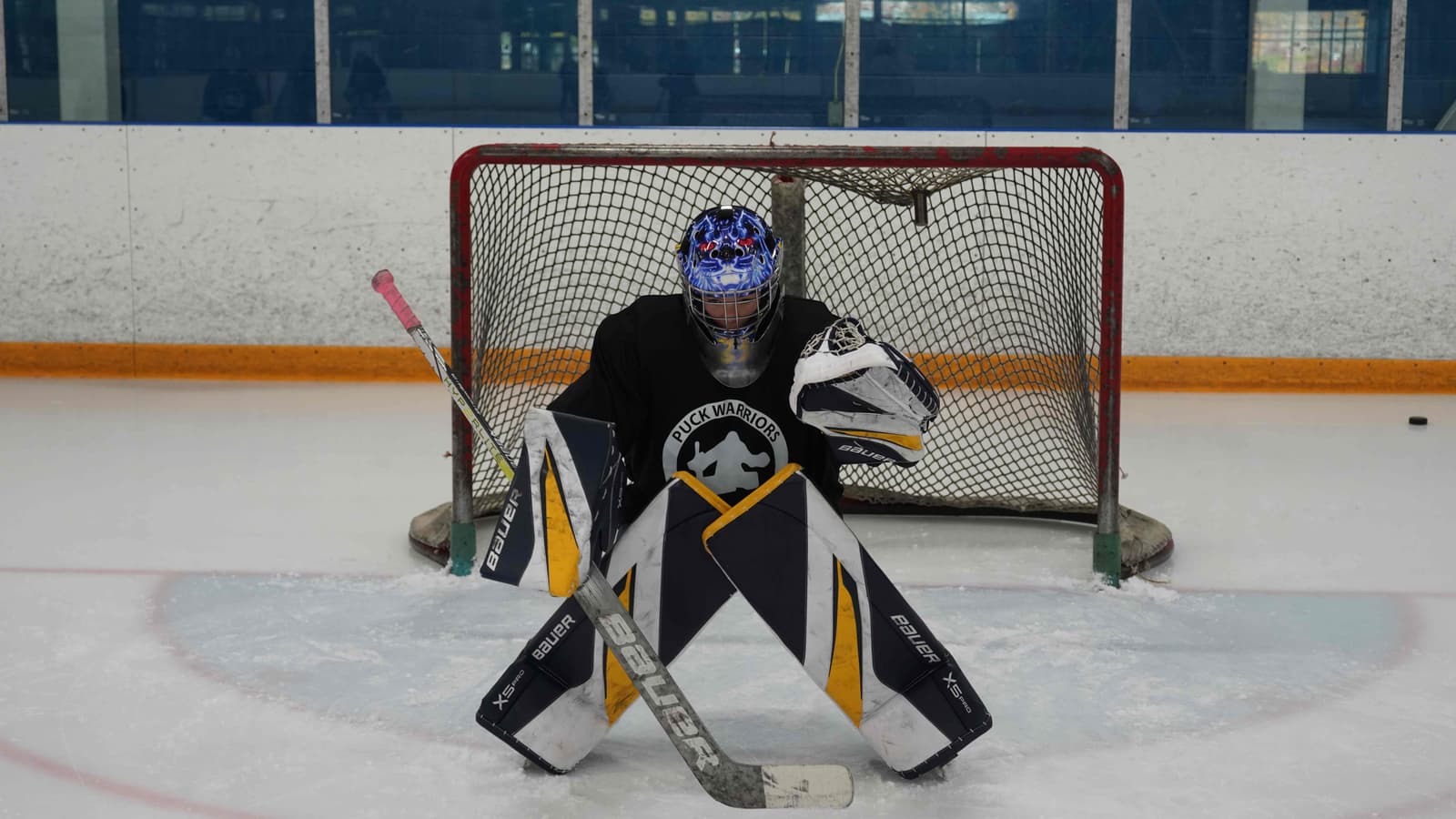 Goalie sealing the ice in a butterfly during a Development Clinic